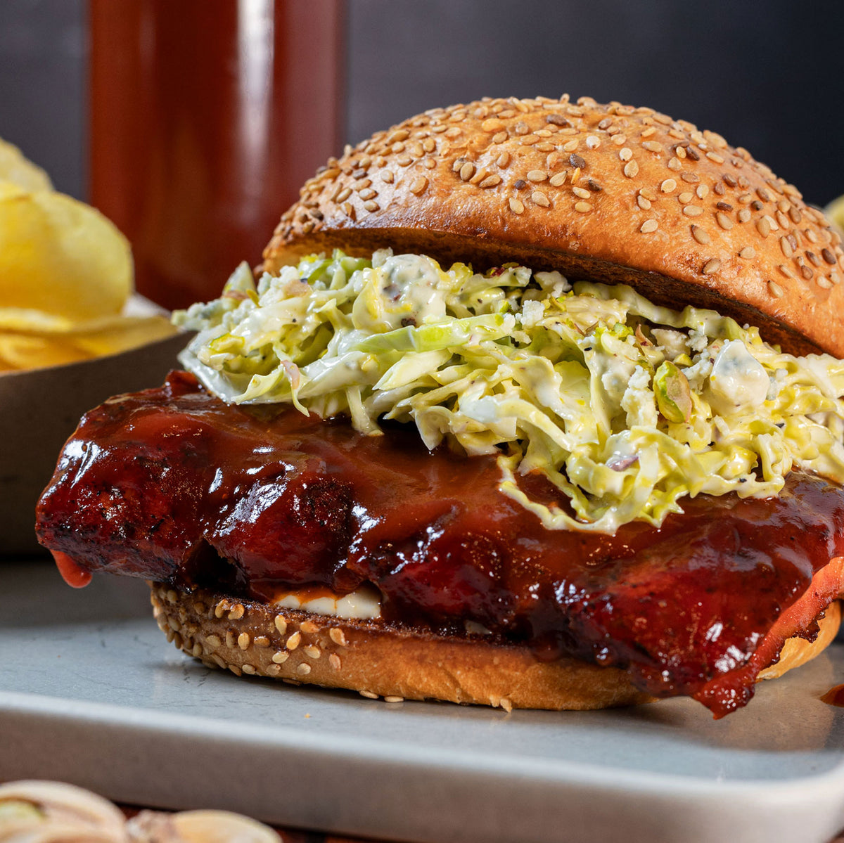 Barbecue rib sandwich with slaw on a sesame bun, glazed with Smoky Sonoran barbecue sauce
