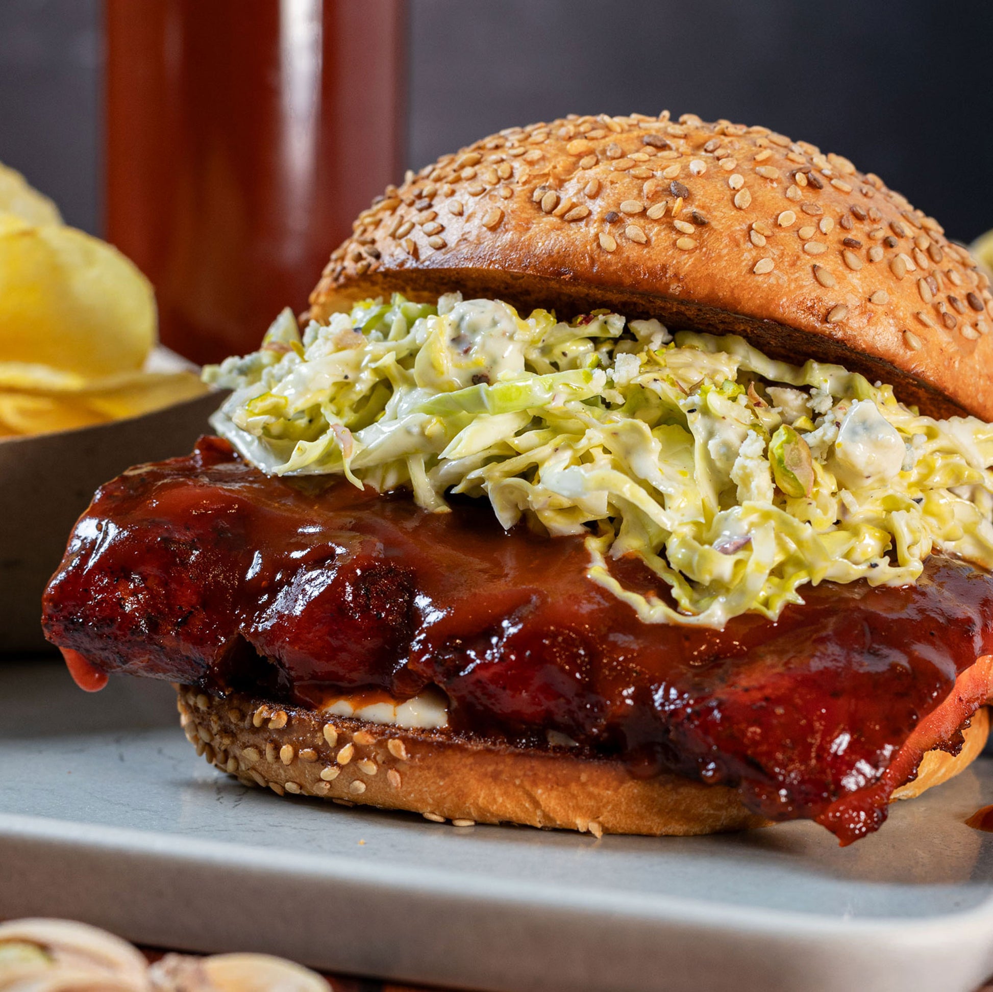 Barbecue rib sandwich with slaw on a sesame bun, glazed with Smoky Sonoran barbecue sauce