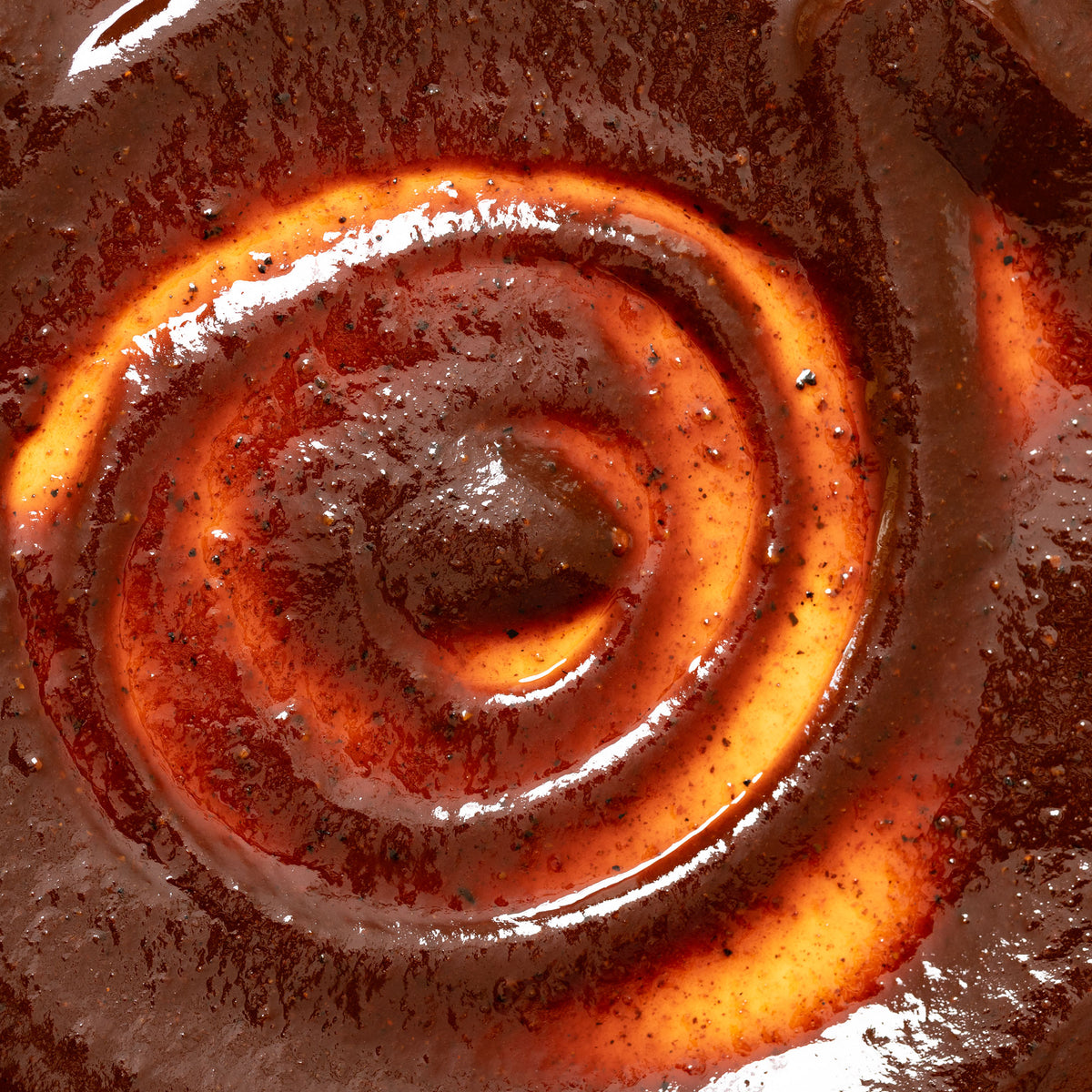 Macro close-up of Smoky Sonoran barbecue sauce swirled thick and glossy in a bowl